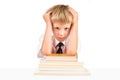 Tired little schoolboy sitting at table Royalty Free Stock Photo