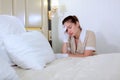Tired maid in a hotel bedroom. The concept of cleaning. Copy of the space. Photo in the interior Royalty Free Stock Photo