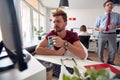 A tired male employee is trying to work in the office. Employees, job, office Royalty Free Stock Photo