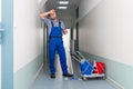 Tired Male Worker Cleaning Office Corridor Royalty Free Stock Photo