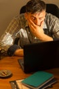 Tired male working on computer Royalty Free Stock Photo