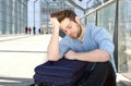 Tired man with bag sleeping at airport Royalty Free Stock Photo