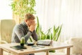 Tired man covering his face with his hands at the workplace at the table Royalty Free Stock Photo