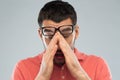 Tired man in eyeglasses rubbing eyes Royalty Free Stock Photo