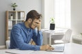 Stressed, exhausted and frustrated young employee has a burnout at work in office Royalty Free Stock Photo