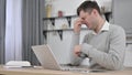 Tired Man having Headache while Working on Laptop Royalty Free Stock Photo