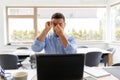 Tired man with laptop working at home office Royalty Free Stock Photo