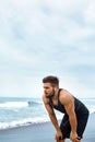 Tired Man Resting After Running On Beach. Sports Workout Outdoor Royalty Free Stock Photo