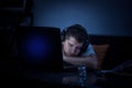 Tired man sleeping behind the laptop because of burnout Royalty Free Stock Photo