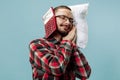 Tired man sleeping at home having too much work. Bored businessman with pillow Royalty Free Stock Photo