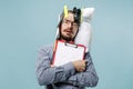 Tired man sleeping at home having too much work. Bored businessman with pillow Royalty Free Stock Photo