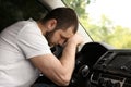 Tired man sleeping on steering wheel in car Royalty Free Stock Photo