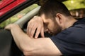 Tired man sleeping on steering wheel in car Royalty Free Stock Photo