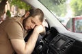 Tired man sleeping on steering wheel in car Royalty Free Stock Photo