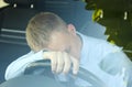 Tired man sleeping on steering wheel in his car, view from outside Royalty Free Stock Photo