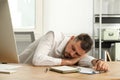 Tired man sleeping at workplace in office Royalty Free Stock Photo