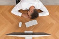 Tired man sleeping at workplace, top view Royalty Free Stock Photo
