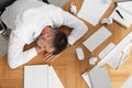 Tired man sleeping at workplace, top view Royalty Free Stock Photo