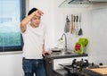 Tired man washing dishes in the sink in kitchen at home Royalty Free Stock Photo