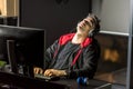 Tired man working by computer in apartment