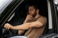 Tired man yawning while driving his car Royalty Free Stock Photo