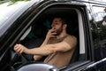 Tired man yawning while driving his car Royalty Free Stock Photo