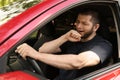 Tired man yawning while driving his car Royalty Free Stock Photo