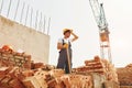 Tired man. Young construction worker in uniform is busy at the unfinished building Royalty Free Stock Photo