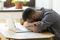 Fatigued and overworked businessman in casual wear sleeping at d Royalty Free Stock Photo