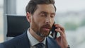 Tired manager talking smartphone hearing bad news closeup. Man feeling stressed.