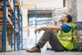 Tired manual worker sitting on floor