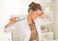 Tired medical doctor woman sitting in office