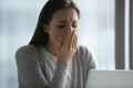 Exhausted female employee sigh feeling fatigue at workplace