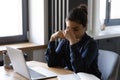 Tired millennial indian woman rubbing nose bridge feeling eye strain