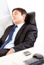 Tired modern businessman sleeping on armchair