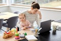 Tired mother with baby working at home office Royalty Free Stock Photo