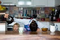 Tired mother, trying to pour coffee in the morning. Woman lying on kitchen table after sleepless night