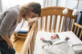 Tired Mother with Upset Baby Suffering with Post Natal Depression. Royalty Free Stock Photo