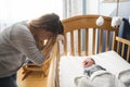 Tired Mother with Upset Baby Suffering with Post Natal Depression. Royalty Free Stock Photo