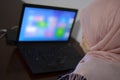 Tired muslim student after online classes holding hands over the face in front of the laptop Royalty Free Stock Photo