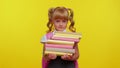 Tired nerdn school girl kid wear backpack holding stack of books, looks exhausted, sad of homework Royalty Free Stock Photo