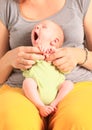 Tired newborn baby boy on momÃÂ´s lap Royalty Free Stock Photo