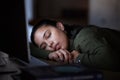 Tired, night and a business woman sleeping at her desk while working overtime in her office. Burnout, deadline and Royalty Free Stock Photo