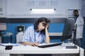 Tired nurse using desktop computer Royalty Free Stock Photo