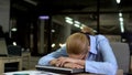 Tired office employee lying on laptop, concept of daily routine and overwork Royalty Free Stock Photo