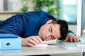 tired office worker sleeping on top keyboard Royalty Free Stock Photo