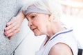 Tired old lady having rest time after training outdoors Royalty Free Stock Photo