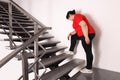 Tired overweight mature woman running upstairs indoors