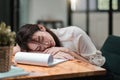 Tired and overworked business woman. Young exhausted girl sleeping on table during her work Entrepreneur, freelance Royalty Free Stock Photo