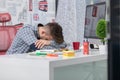 Tired overworked businessman sleeping over a desk at job in his office Royalty Free Stock Photo